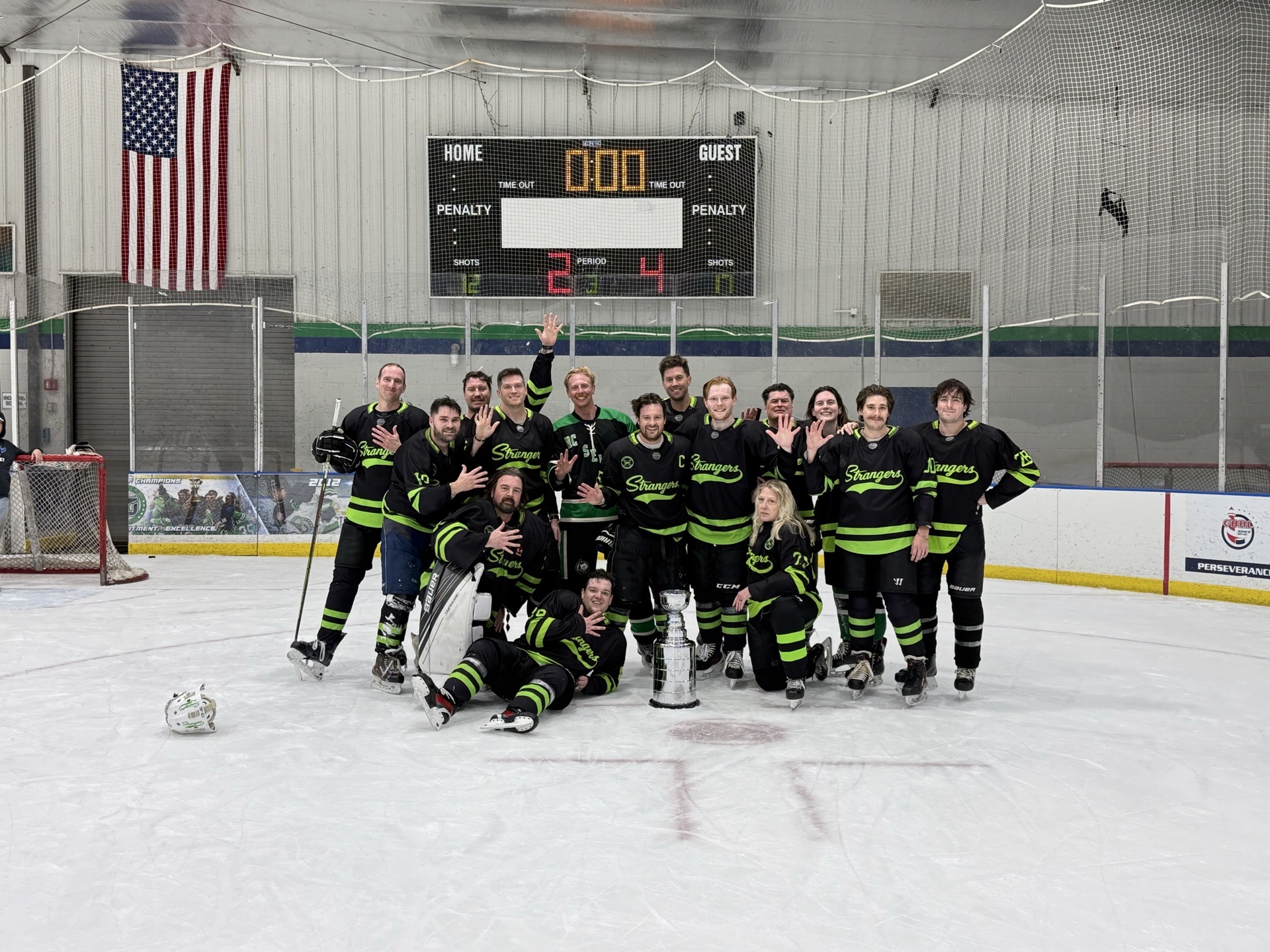 The Strangers celebrate their Fall 2025 championship on the ice.