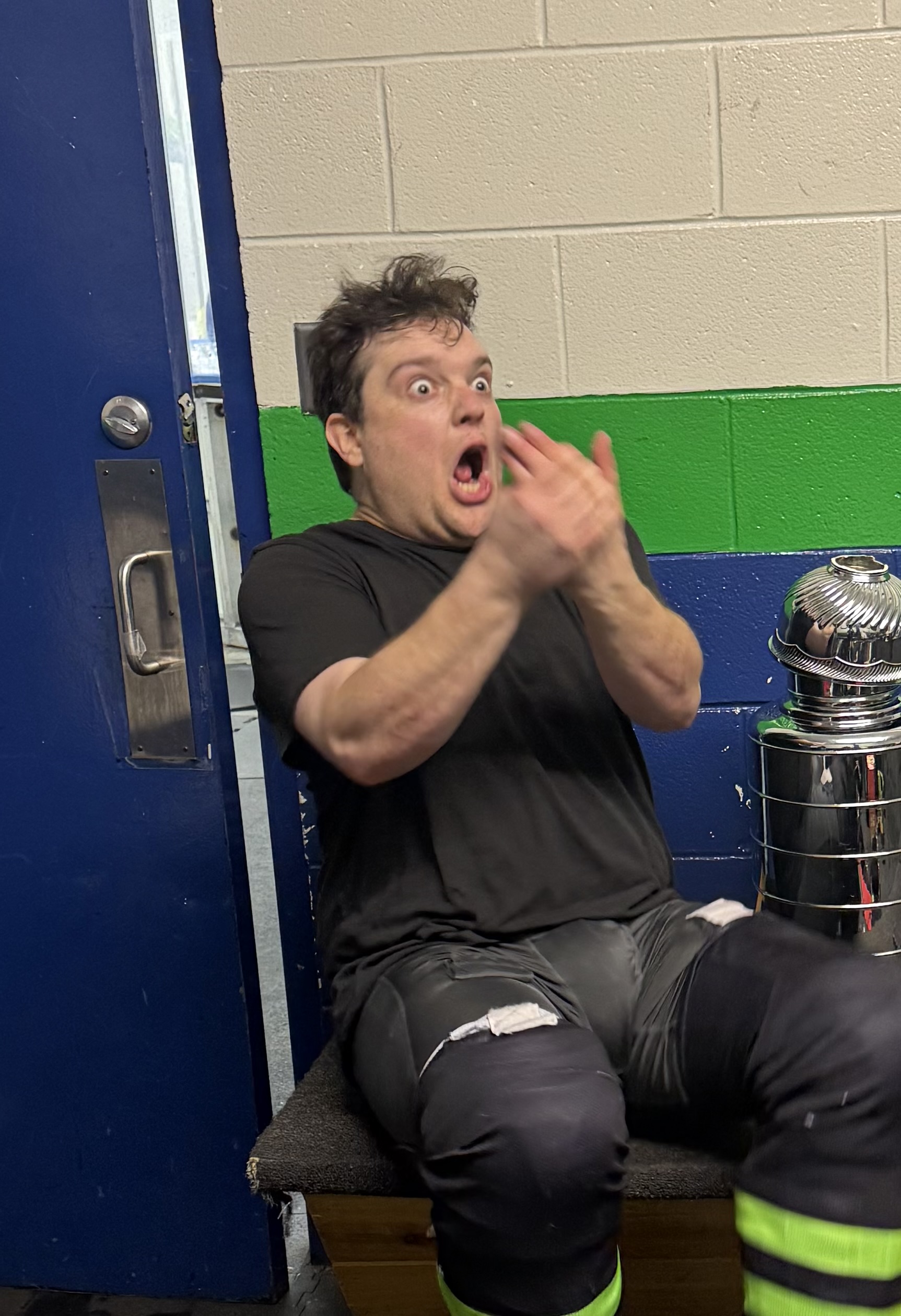 John Musson celebrates beside the championship trophy.